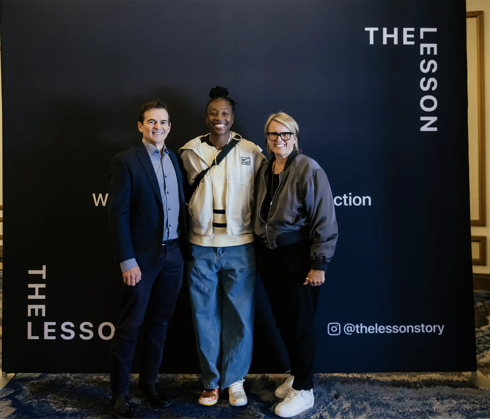 Reed Frerichs, WNBA All-Star Jewell Loyd and a speaker in front of The Lesson backdrop at SXSW 2026